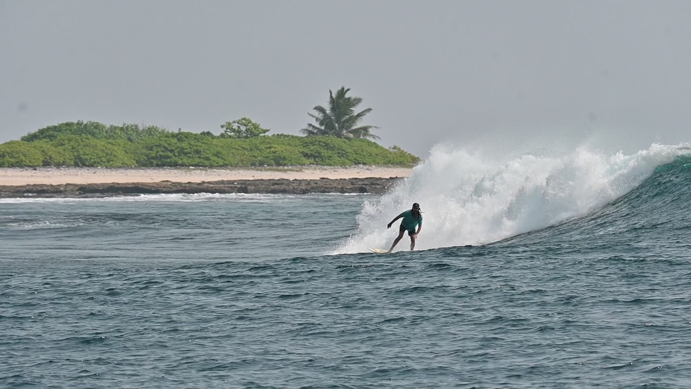 Surfer on a wave in the Andaman Islands